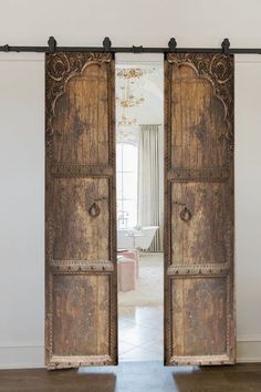 an open wooden door in the middle of a room