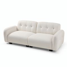 a white couch sitting on top of a white floor