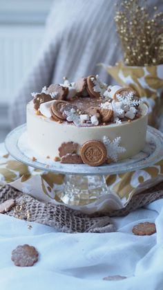 a cake with cookies and marshmallows on it