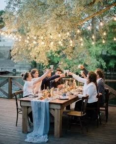 a group of people sitting around a wooden table