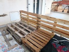 a wooden bench sitting on top of a tiled floor next to a door and window