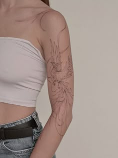 a woman with a bird tattoo on her left arm and right arm behind her back