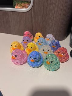 a group of rubber ducks sitting on top of a white counter next to a window