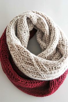 two knitted scarves sitting on top of each other