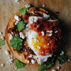 an egg is sitting on top of some bread and garnished with parsley