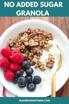 granola with yogurt, berries and blueberries in a white bowl on a wooden table