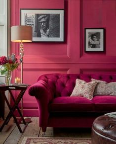 a living room with pink walls and furniture