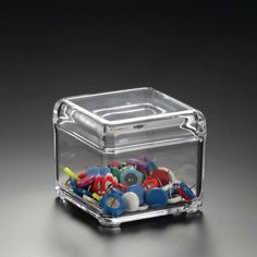 a clear container filled with lots of different colored buttons