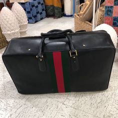 Vintage Black Leather Gucci Luggage with Handles Original lock and key + Luggage tag. Gucci logos and stamps Lining in good condition Very heavy, no tarnishing on gold tone hardware. Note: My client's grandparents were station in Italy in the Military (1960's) and the Grandmother bought this bag when they came back to the USA. For many years was used as display in her family house walk-in closet. Size:27w x 8d x 17h Gucci Luggage, Trolley Bags, Closet Size, Lock And Key, The Military, Family House, Walk In Closet, Luggage Tag, Luggage Tags