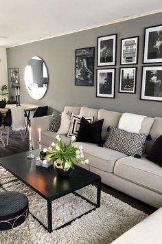 a living room filled with lots of furniture and pictures on the wall above it's coffee table