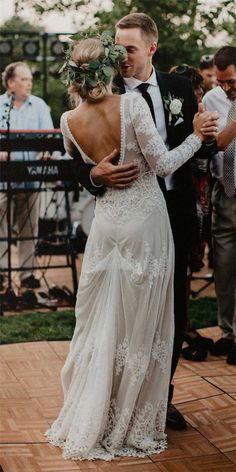 a bride and groom dance together on the dance floor at their wedding reception in an outdoor venue