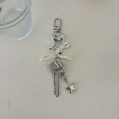 Embrace the coquette trend with our Swifty Keychain, featuring a variety of charming layers. This lovely keyring includes a metal vintage-style key, a cute star charm, and a delicate pearl-beaded ribbon, making it a unique and stylish accessory. Add a whimsical touch to your bag or keys, and let this keychain symbolize unlocking joyful and lovely moments in your everyday life. Perfect for adding a playful, yet elegant vibe to any look! Materials: Stainless steel key charm Acrylic pearl beads Beaded Ribbon, Ribbon Making, Lovely Moments, Cute Star, Cute Stars, Diy Keychain, Vintage Diy, Diy Charms, Star Charms