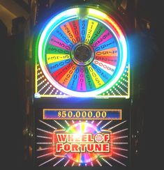 a wheel of fortune machine with neon lights