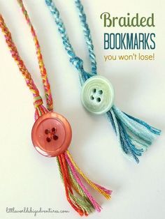 three different colored threaded necklaces with buttons and tassels attached to them