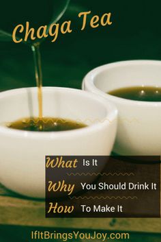 two white bowls filled with green tea sitting on top of a wooden table