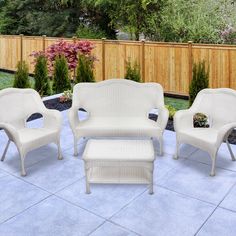 three white wicker furniture sitting on top of a patio