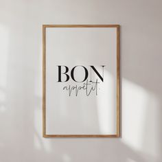 a wooden frame hanging on the wall above a poster that says boni an artful