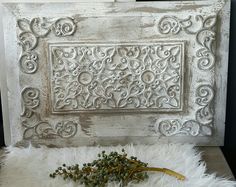 a bunch of flowers sitting on top of a white fur covered floor next to an old door