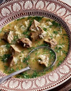 a bowl of soup with meat and parsley