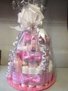 a baby shower gift basket with pink and white items