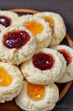 there is a plate full of cookies with jam on them