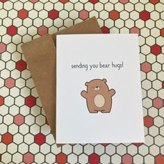 a card with a brown bear on it and the words sending you bear hugs written in black ink