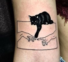 a black cat sitting on the arm of someone's hand with another hand reaching for it