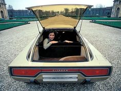 a woman is sitting in the back of a car