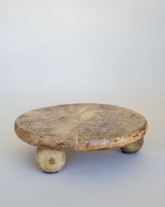 a wooden skateboard sitting on top of a white surface