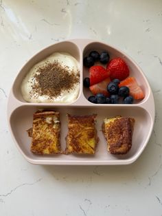 a pink plate topped with toast, fruit and yogurt