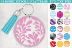 a round keychain with flowers and leaves on it, surrounded by different colored circles