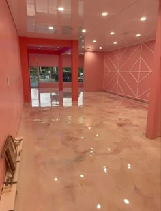 an empty room with pink walls and white floors