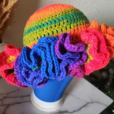 there is a colorful hat on top of a blue vase