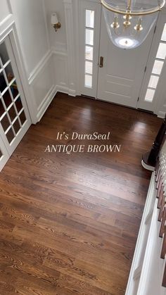 the entrance to an antique brown house with its name on it's front door