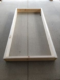 a wooden frame sitting on top of a carpeted floor