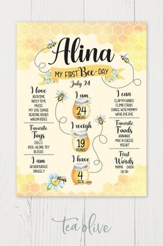 a baby's first bee day sign with bees and honeycombs on it