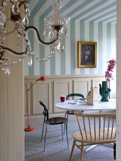 a dining room with blue and white striped walls