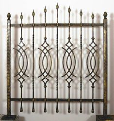 an old iron fence with decorative designs on it