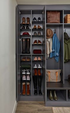 an organized walk in closet with shoes and bags