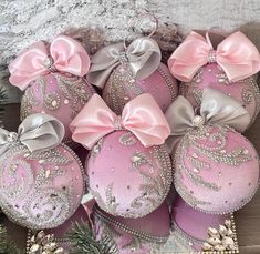 pink and silver ornaments with bows on them