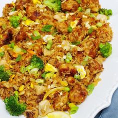 a white plate topped with fried rice and broccoli