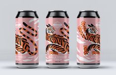 three cans of soda with an orange and black tiger on the front one is pink