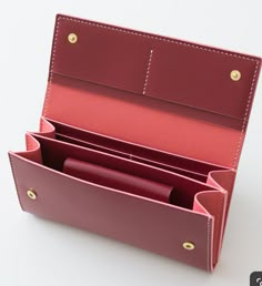 an open red leather case on a white surface