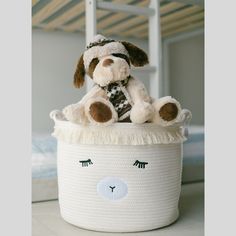 a stuffed dog is sitting in a basket