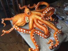 an orange octopus sculpture sitting on top of a table