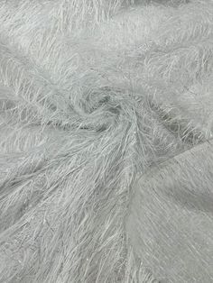 an up close shot of the texture of a fur - like material that is light gray