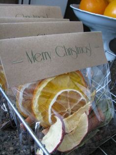 there are oranges and apples in the basket on the counter with merry christmas signs