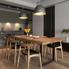 a dining room table with four chairs and a bowl of flowers on the table in front of it