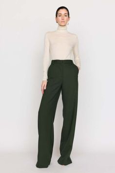 A timeless bootcut silhouette our cora pant is made from our italian twill suiting that’s blended with wool. this high-waist style features a front fly with zipper and a wide cuff at the hem. this classic forest hue invites neutrality and versatility to your wardrobe.    composition: wool twill  care: dry clean only  imported. Formal Wool Wide Leg Pants For Spring, Elegant Wool Wide Leg Pants For Spring, Elegant Wide Leg Wool Pants For Spring, Fall Workwear Pants With Straight Hem, Fall Business Casual Wide-leg Dress Pants, Straight Hem Pants For Workwear In Fall, Tailored Wide-leg Dress Pants For Fall, Tailored Full Length Wide Leg Fall Pants, Fall Wide Leg Workwear Pants