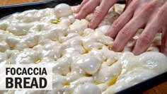 two hands reaching for food in a pan on a table with the words focaccia bread